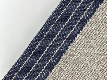 Close-up of fabric textures with navy and beige stripes.