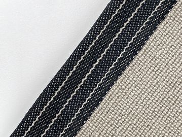 Close-up of black and beige textured fabric with stripes.