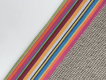 Colorful striped rug next to a textured gray carpet.