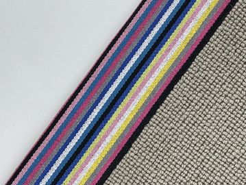 Close-up of colorful striped fabric with textured background.