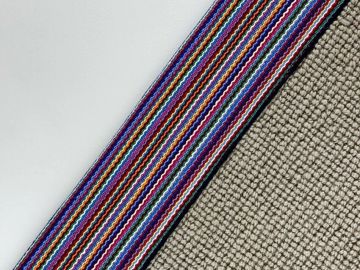 Striped ribbon on textured fabric.