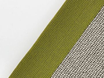 Close-up of green fabric next to textured gray material.