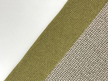 Close-up of textured fabric in olive green and beige colors.