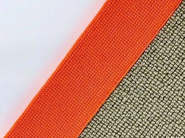 Close-up of orange and beige textured fabric edges.