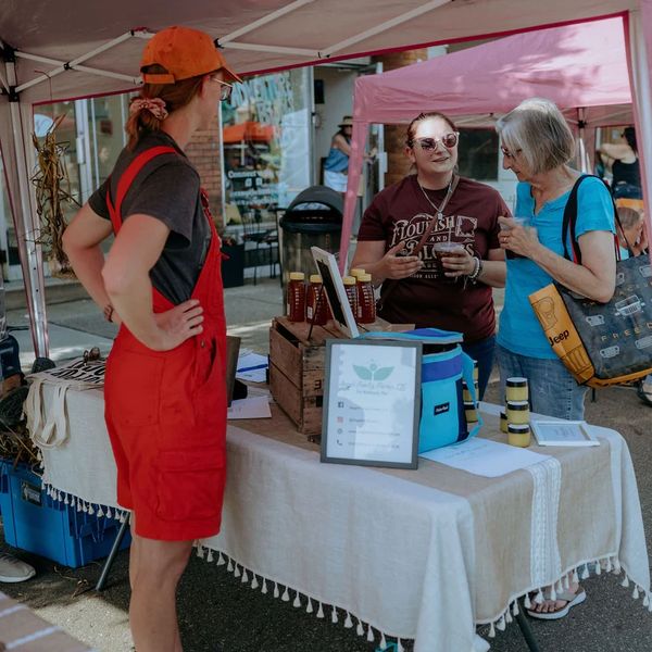 Angel Family Farms and Sander’s Homestead talking with Twin City Farmers Market Customers