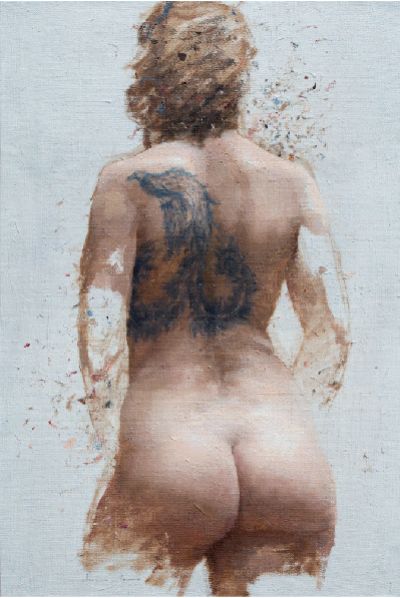 Back view of a nude person with a large tattoo on the back.