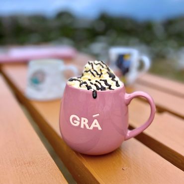 A group of friends enjoying coffee and treats at Carrauntoohil Coffee Hut, a welcoming stop