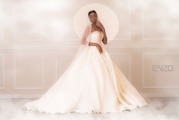 Elegant bride in a detailed white wedding gown with veil.