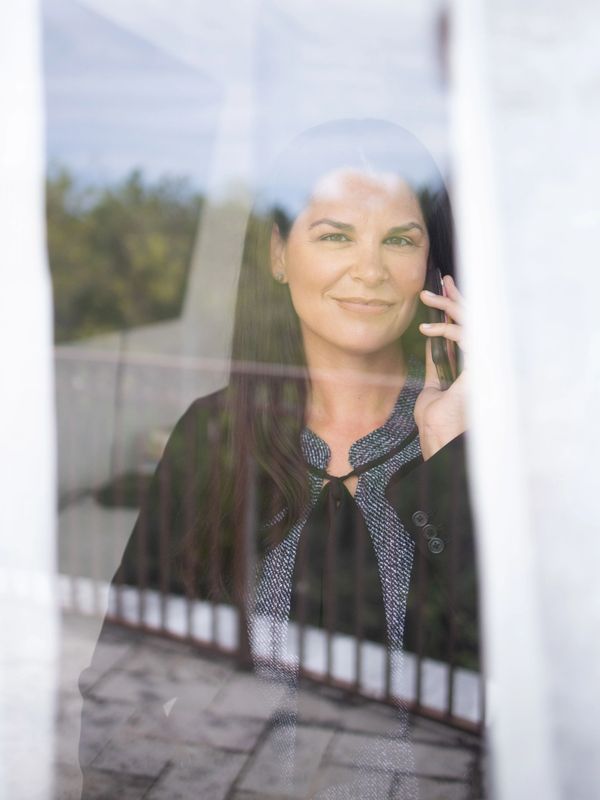 a woman on the phone behind a window