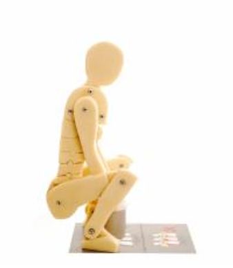 A dummy demonstrating how to bend knees with a heavy weight