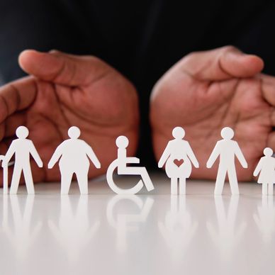 Hands cupped behind cut out images of people with disabilities,children and people young and old. 