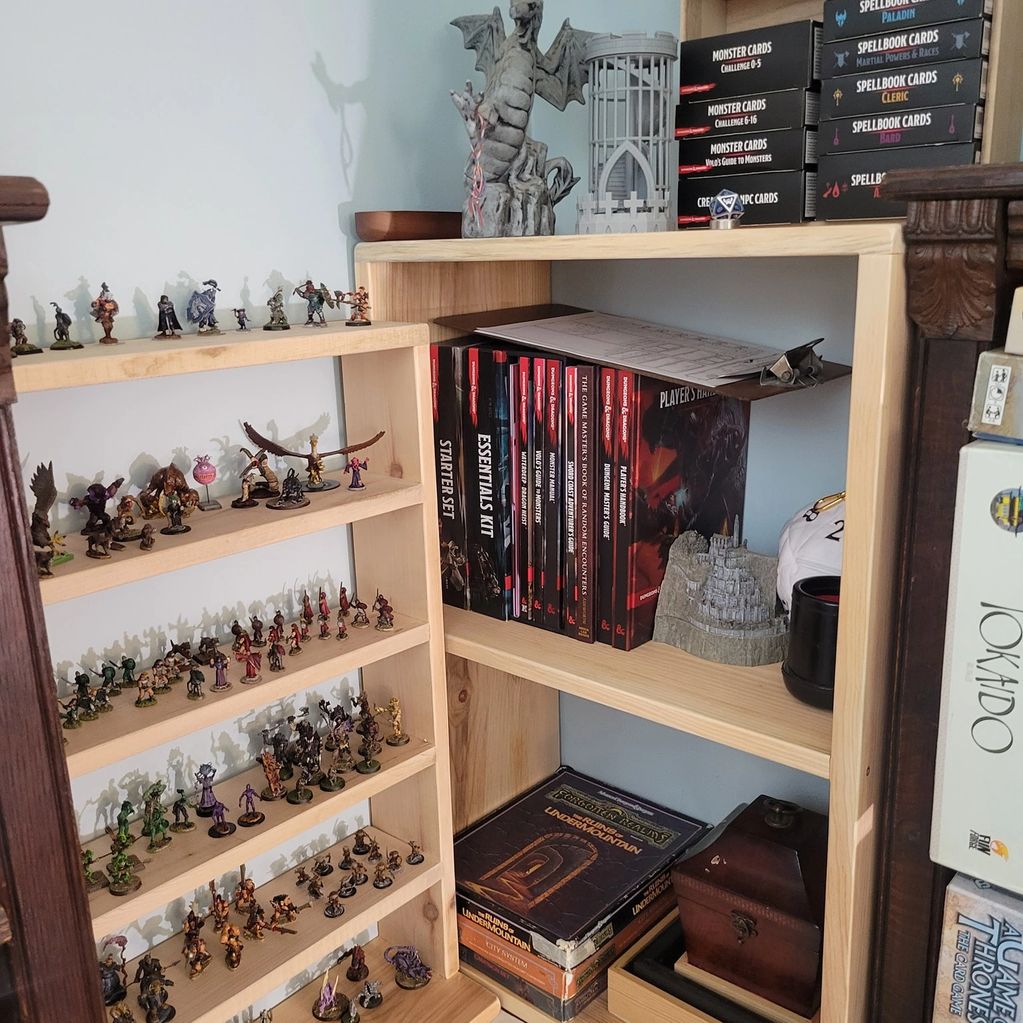 A wooden shelf filled with Dungeons & Dragons books, miniatures, and game accessories.