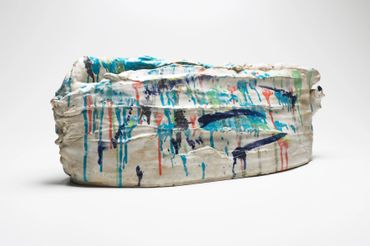 Clay pot with colourful abstract pattern.