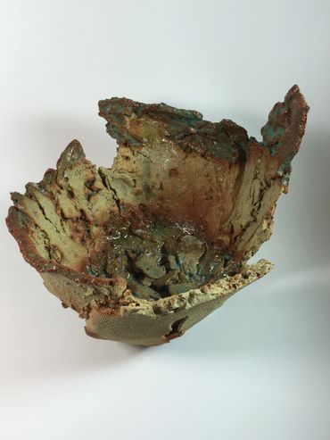 Clay pot with distressed and torn edges.
