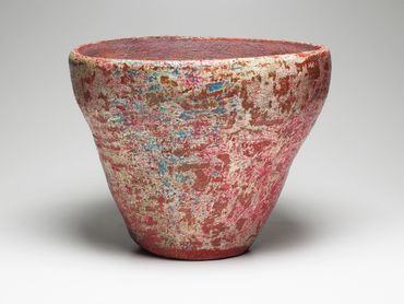 Clay bowel with abstract pinkish-red pattern.