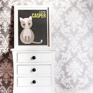White dresser with a framed cat illustration titled 'C is for Casper.'