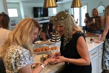 a woman reading the palm of another woman