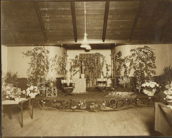 Vintage indoor floral display with potted plants and flowers.