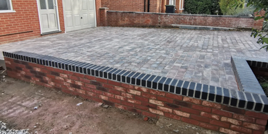 Brick wall built around driveway.