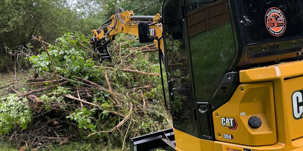 Mini excavator piling up debris in Seymour Tennessee.