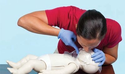 Person performing CPR on a baby mannequin.