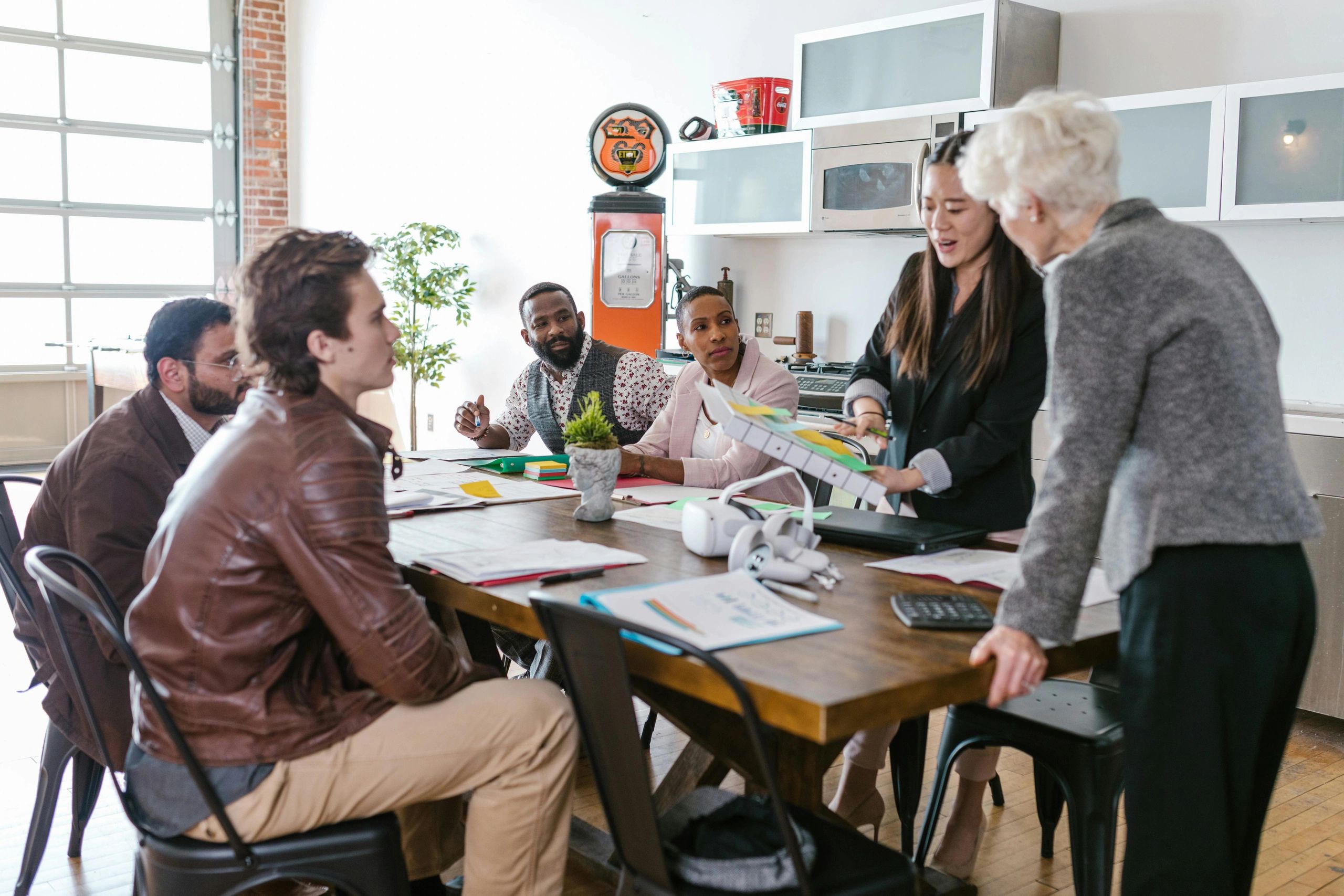Diverse team collaborating in a modern office meeting.