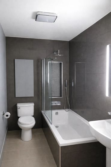 Modern bathroom remodel featuring porcelain tile and walk-in shower tile installation.