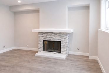 Family room renovation with fireplace upgrade, new stone veneer installation, fresh painting, and up