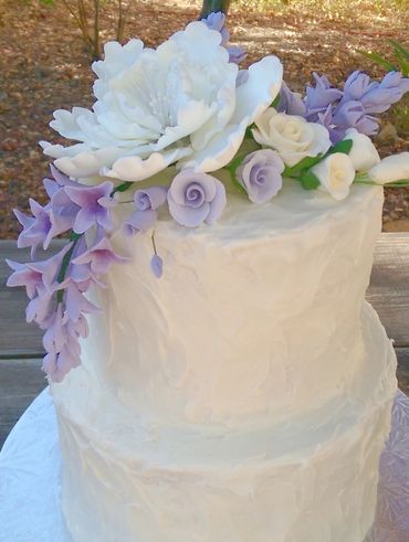 Rustic buttercream and lilac flowers simple wedding cake