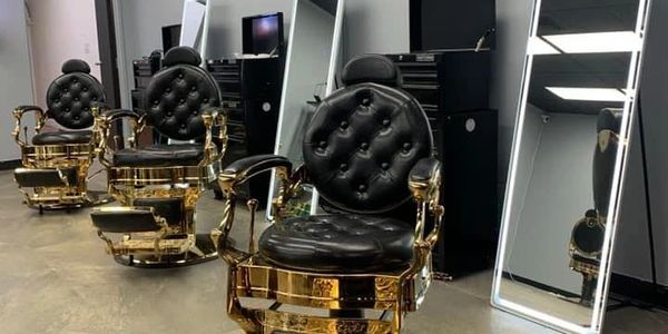 Gold modern barber chairs and led mirrors.