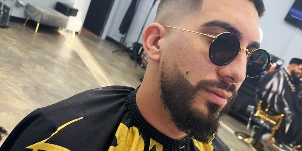 Detailed mid fade with beard lineup.