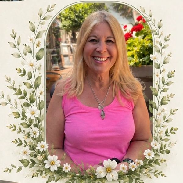 Smiling woman in a pink tank top framed by floral design.