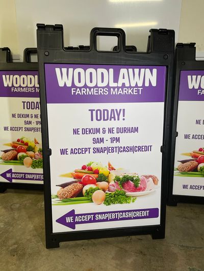 A board signs for a farmers market