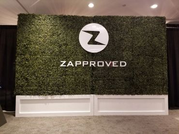 Boxwood hedge wall and custom signage for step and repeat at private corporate event.