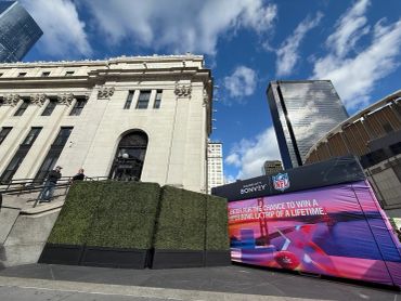 10' tall boxwood hedges rented to hide generator and audio equipment for NFL activation at Moynihan