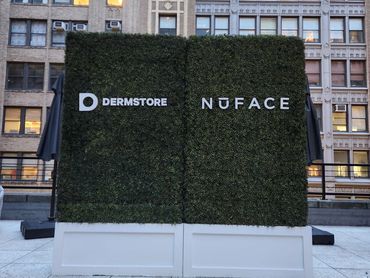 10' Tall Boxwood Hedge Rental with Custom Signage for Corporate Event