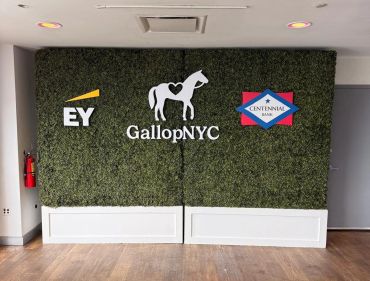 8' tall boxwood hedges with custom, multi-color signage rented for corporate activation.