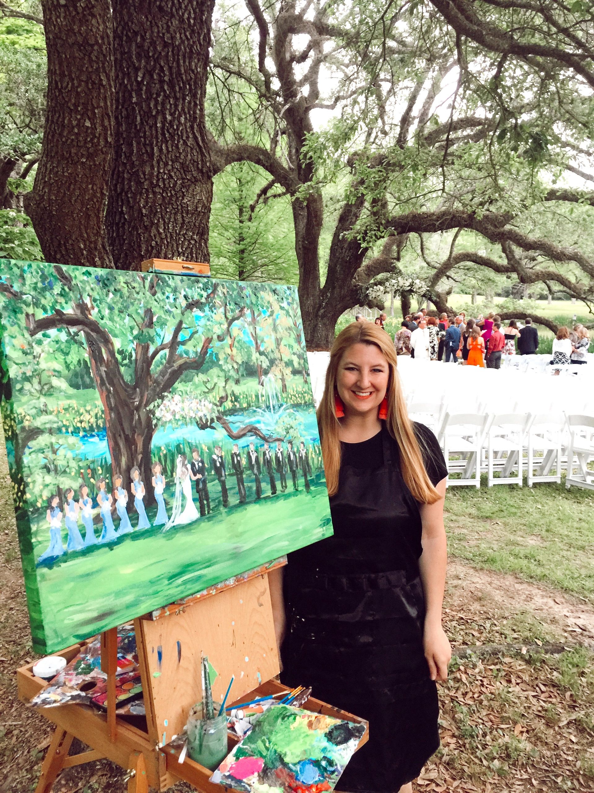 woman artist painting a wedding ceremony live surrounded by trees