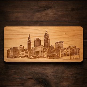 Wooden plaque with a detailed city skyline engraving.