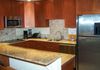AFTER- The cabinets were painted to match the existing cherry seen under the island.