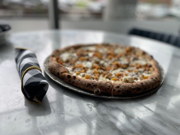 Neapolitan pizza on white marble table