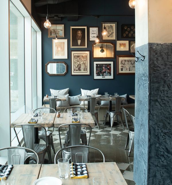 Pictures on an art wall with tables and chairs