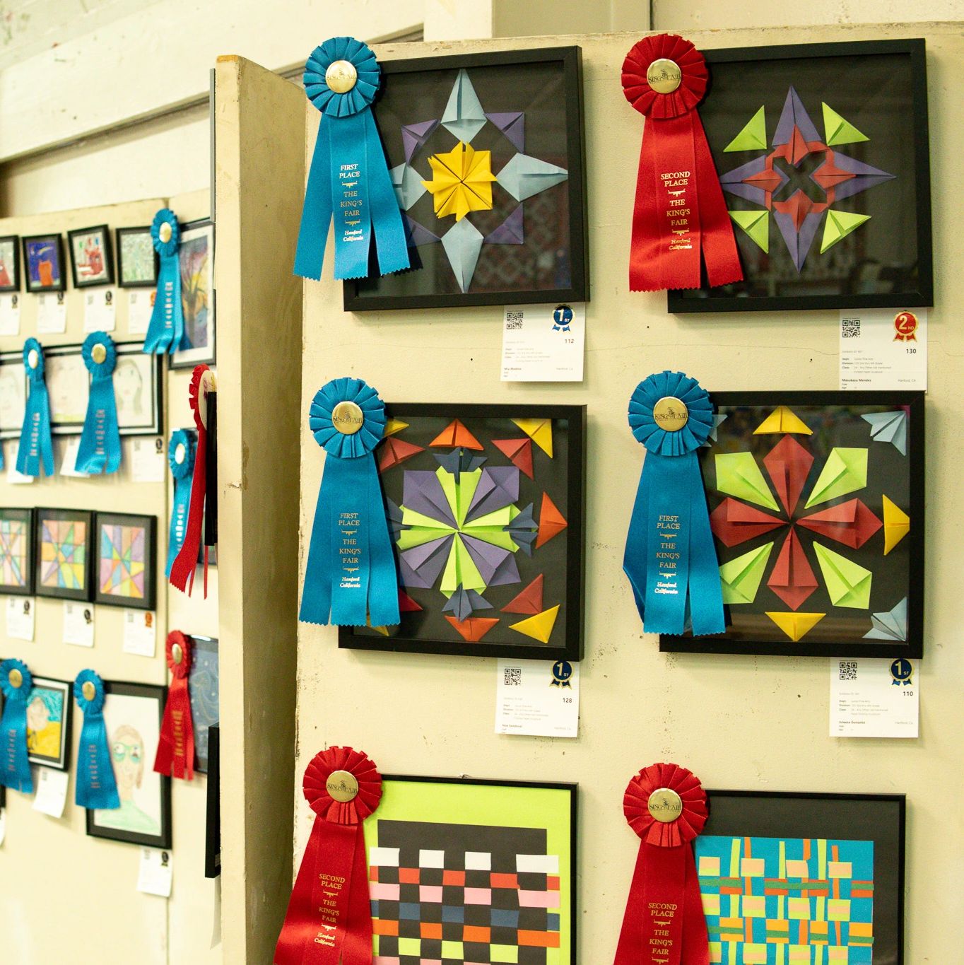 Image of paper crafts with blue & red ribbons displayed