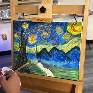 Painting inspired by Starry Night on an easel.
