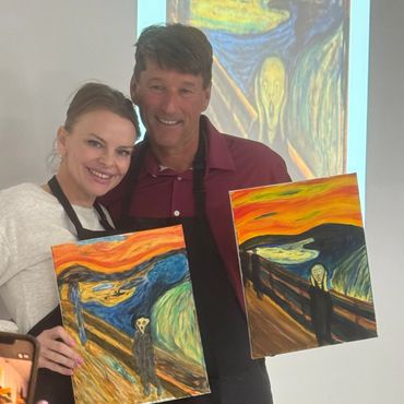 Two people proudly display paintings inspired by The Scream.