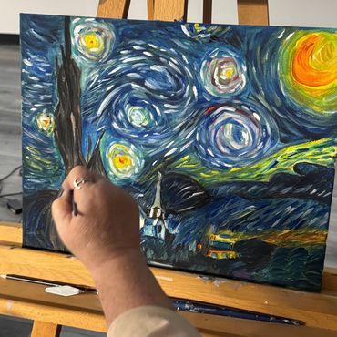 Person painting a version of Starry Night.