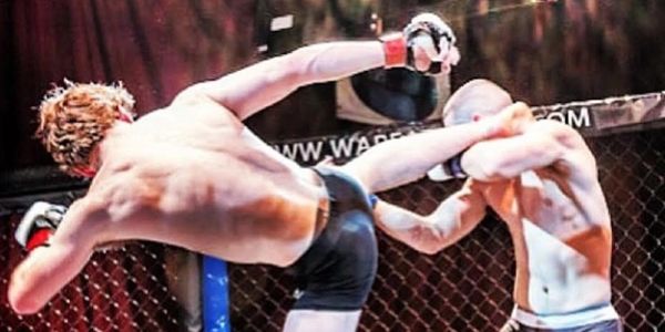 Two MMA fighters in action inside the cage.