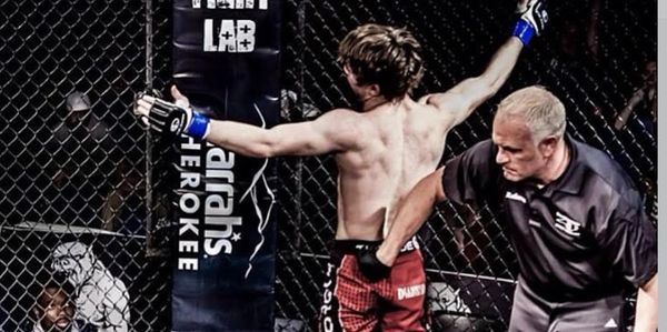 Referee stopping an MMA fight in the cage.