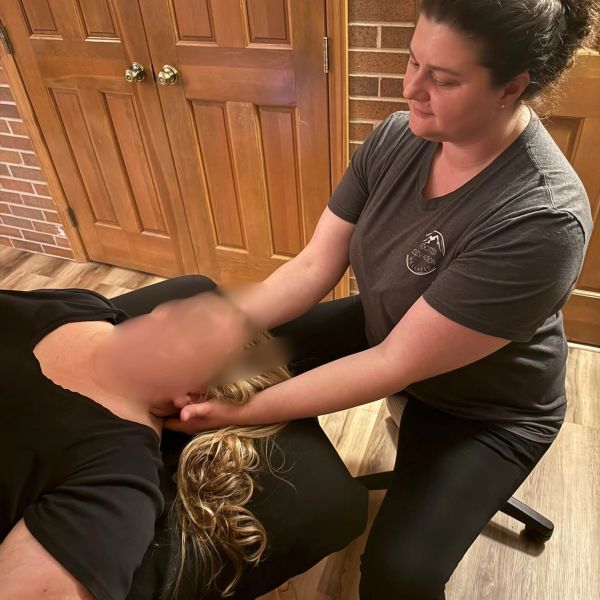 Therapist giving a neck massage to a client.