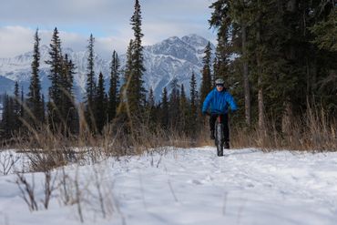 fat biking on snow with mountains pyramid mountain winter jasper